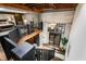 Spacious open floor plan featuring a staircase, exposed brick, and a chandelier with an upper level with a bedroom at 1570 Dekalb Ne Ave # F, Atlanta, GA 30307