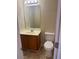 Cozy bathroom featuring a single sink vanity and toilet at 2127 Manhattan Pkwy, Decatur, GA 30035