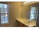 Bright bathroom with vanity, sink, mirror, and window at 2127 Manhattan Pkwy, Decatur, GA 30035