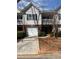 Charming townhome with a one-car garage and a well-maintained front lawn at 2127 Manhattan Pkwy, Decatur, GA 30035