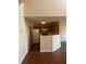 A kitchen with hardwood floor, featuring a white refrigerator and wooden cabinets and neutral-colored walls at 2127 Manhattan Pkwy, Decatur, GA 30035