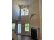 Bright living room with a ceiling fan, fireplace and lots of natural light from the multiple windows at 2127 Manhattan Pkwy, Decatur, GA 30035
