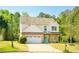 Two-story home features a well-maintained lawn, a two-car garage, brick accents and a welcoming entrance at 2365 Oakland Trail Way, Lawrenceville, GA 30044