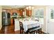 Bright eat-in kitchen features stainless steel appliances, wood cabinets, and an adjacent breakfast nook with natural light at 2365 Oakland Trail Way, Lawrenceville, GA 30044