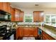 Bright kitchen with stainless steel appliances, granite counters, stylish backsplash and a view of the backyard at 2365 Oakland Trail Way, Lawrenceville, GA 30044