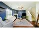 Cozy living room featuring a fireplace, comfortable seating, and a large rug on hardwood flooring at 2365 Oakland Trail Way, Lawrenceville, GA 30044