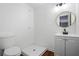 Modern bathroom featuring a shower, vanity, round mirror and a toilet at 2541 Peyton Woods Sw Trl, Atlanta, GA 30311