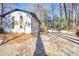 Side exterior featuring a white painted brick, an attached garage and a deck at 2541 Peyton Woods Sw Trl, Atlanta, GA 30311