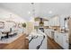 Modern kitchen with waterfall island, seating, and sleek white cabinets at 2541 Peyton Woods Sw Trl, Atlanta, GA 30311