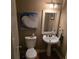 Compact bathroom featuring a pedestal sink, toilet, decor and art at 278 Mission Oak Se Dr, Grayson, GA 30017
