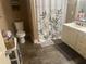 Bathroom featuring dark tile flooring, a single sink vanity, and a leaf-patterned shower curtain at 278 Mission Oak Se Dr, Grayson, GA 30017