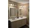 Bathroom featuring double vanity sinks, decorative mirrors, and ample lighting at 278 Mission Oak Se Dr, Grayson, GA 30017