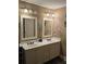 Bathroom featuring double vanity, framed mirrors, lighting fixtures, and decorative fish art at 278 Mission Oak Se Dr, Grayson, GA 30017