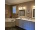 Bathroom featuring dual vanity, garden tub, and elegant finishes at 278 Mission Oak Se Dr, Grayson, GA 30017