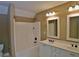 Bathroom with double vanity, framed mirrors, lighting fixtures, and shower-tub combo at 278 Mission Oak Se Dr, Grayson, GA 30017