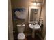 Powder room featuring a pedestal sink, framed mirror, and wall art at 278 Mission Oak Se Dr, Grayson, GA 30017