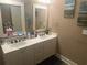 Bathroom featuring double vanity, framed mirrors, and decorative fish art at 278 Mission Oak Se Dr, Grayson, GA 30017