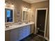 Bathroom featuring a dual vanity, white cabinets, and elegant lighting at 278 Mission Oak Se Dr, Grayson, GA 30017
