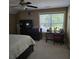 Bedroom with ceiling fan, window view, study desk, and dark wood dresser at 278 Mission Oak Se Dr, Grayson, GA 30017