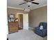 Cozy bedroom with plush armchair, traditional wood dresser, and neutral carpet at 278 Mission Oak Se Dr, Grayson, GA 30017