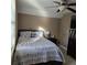 Bedroom featuring a bed with floral bedding, a ceiling fan, and natural light at 278 Mission Oak Se Dr, Grayson, GA 30017