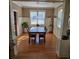 Traditional dining room featuring a dark wood table, hardwood floors, and bright natural lighting at 278 Mission Oak Se Dr, Grayson, GA 30017