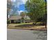 Charming single-story home with a well-manicured lawn, mature trees, and a welcoming front porch at 278 Mission Oak Se Dr, Grayson, GA 30017