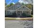 Charming home featuring manicured landscaping, gray facade, and inviting front porch at 278 Mission Oak Se Dr, Grayson, GA 30017