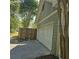 Attached two-car garage with white door and gray siding; driveway and privacy fence included at 278 Mission Oak Se Dr, Grayson, GA 30017