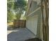 Attached two-car garage with concrete driveway and partial wooden fence at 278 Mission Oak Se Dr, Grayson, GA 30017