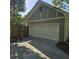 Attached two-car garage with concrete driveway and partial wooden fence at 278 Mission Oak Se Dr, Grayson, GA 30017