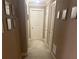 Narrow hallway with light carpet, with framed pictures along the wall and doors on either side at 278 Mission Oak Se Dr, Grayson, GA 30017