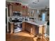 Cozy kitchen featuring stainless steel appliances, wood cabinets and stylish tile backsplash at 278 Mission Oak Se Dr, Grayson, GA 30017