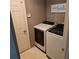 Laundry room featuring a washer, dryer, neutral walls, and a door at 278 Mission Oak Se Dr, Grayson, GA 30017