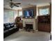 Living room featuring a fireplace, built-in cabinets, a ceiling fan, and large windows at 278 Mission Oak Se Dr, Grayson, GA 30017
