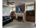 Comfortable living room with a fireplace, built-in bookshelves, and a ceiling fan at 278 Mission Oak Se Dr, Grayson, GA 30017