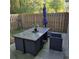 Outdoor patio area with dark wicker dining table and seating with privacy fence at 278 Mission Oak Se Dr, Grayson, GA 30017