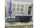 Outdoor patio with dining table, umbrella, and gray siding on the house at 278 Mission Oak Se Dr, Grayson, GA 30017