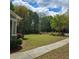 Lush green lawn with mature landscaping and sidewalk at 278 Mission Oak Se Dr, Grayson, GA 30017