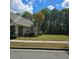 Property showcasing lush green lawns and mature trees, surrounded by a sidewalk at 278 Mission Oak Se Dr, Grayson, GA 30017