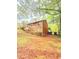 A view of the backyard of the house with grass and foliage and some trees at 1445 Diplomat Dr, Riverdale, GA 30296