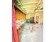 Unfinished basement with work tables, shelving and stained concrete flooring at 1445 Diplomat Dr, Riverdale, GA 30296
