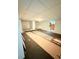 Unfinished basement with drop ceiling and potential for customization with a window to the outside at 1445 Diplomat Dr, Riverdale, GA 30296