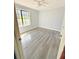 Bright bedroom featuring gray floors, natural light from a large window, and a ceiling fan at 1445 Diplomat Dr, Riverdale, GA 30296