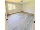 Light, bright bedroom with vinyl flooring, a window, and neutral paint at 1445 Diplomat Dr, Riverdale, GA 30296