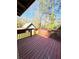 An outdoor deck offers a serene backyard view surrounded by lush trees and a shed at 1445 Diplomat Dr, Riverdale, GA 30296