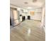 Bright kitchen with white cabinets, stainless steel appliances, and new vinyl flooring at 1445 Diplomat Dr, Riverdale, GA 30296