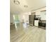 Modern kitchen with stainless steel appliances, light cabinets, and vinyl flooring at 1445 Diplomat Dr, Riverdale, GA 30296