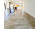 An open-concept living room and kitchen with light-colored walls and modern vinyl flooring at 1445 Diplomat Dr, Riverdale, GA 30296