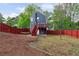 Two-story house with a wood deck overlooking a large fenced backyard and mature trees at 1647 Imperial Ct, Norcross, GA 30093